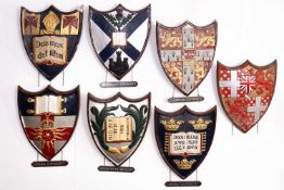 A collection of painted plaster school and university heraldic shields