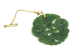 A green hardstone carved pendant, 5.8cm long inclu