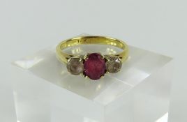 A ruby and white sapphire three stone ring, all cl
