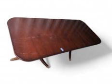 A 20th century mahogany extendable dining table in