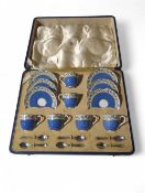 A cased set of Royal Worcester coffee cups and sau