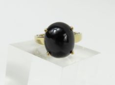 A 9ct gold black onyx dress ring, the oval cabocho