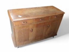 A mid century style sideboard on spherical casters