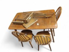 An Ercol style extendable dining table with four c