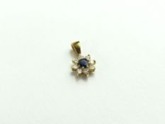 An unmarked gold sapphire and diamond pendant, the