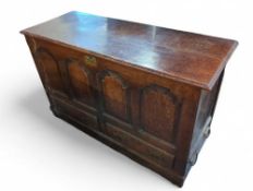A 19th century stained oak mule chest upon plinth
