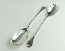 A pair of silver serving spoons, each smooth with