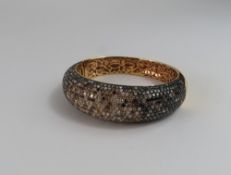 A multi coloured diamond set bangle, one half of t