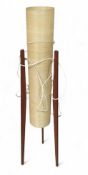 A mid-century rocket lamp on three extruding teak legs.