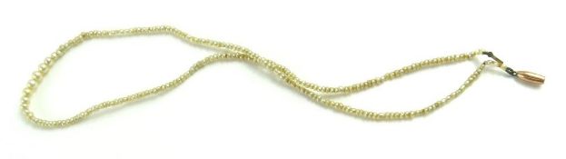 A row of very small graduated pearls, the largest