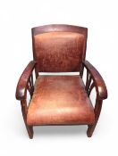 An Art Deco low leather armchair with stained
