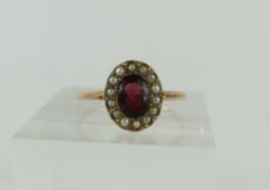 A 9ct rose gold garnet and split pearl cluster rin
