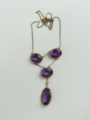 A 19th century amethyst and purple glass necklace, with two oval fa