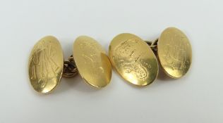 A pair of 18ct gold cufflinks, the oval panels wit