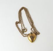 A puffed heart shaped pendant star set with a smal
