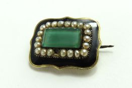 A late Georgian mourning brooch set with glass, se