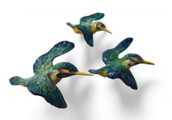 A set of three Beswick pottery wall mounted kingfishers in flight