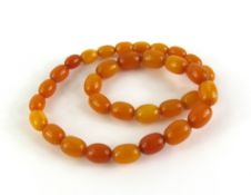 A single row necklace of thirty-three oval opaque
