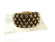 A 9ct gold wide ball and shot ring