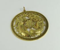 A 20th century Chinese pendant, the round disc wit