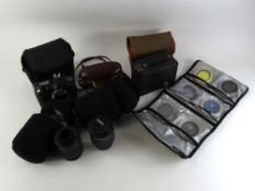 A collection of vintage and other cameras and camera lenses