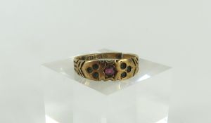 A late 19th or early 20th century Victorian 9ct red stone ring