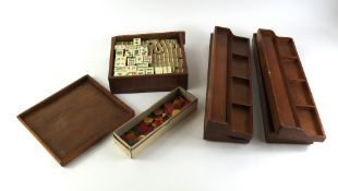 A cased mahjong set, along with wooden tiles,