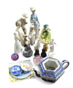 A collection of glassware and porcelain figurines.