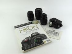 Three camera lenses and a Nikon flash