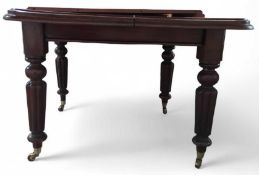 A mahogany extendable dining table