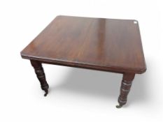 A mahogany extendable dining table