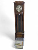 An Art Deco oak long case clock, the round silvere