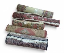 Five medium-sized rugs of different colours and de