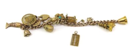 A gold charm bracelet, the hollow curb link chain