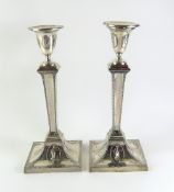 A pair of silver candlesticks, in the form
