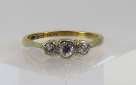 A diamond three stone ring, the three round cut st