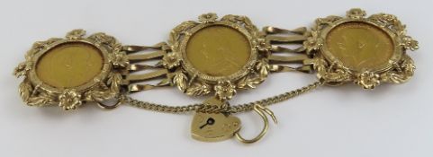 A 9ct gold gate bracelet with three sovereigns in floral mounts