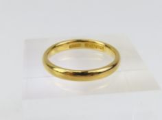 A 22ct gold wedding band, made by Kinsey Brothers