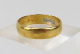 A plain 22ct wedding band, 5mm wide