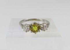 A yellow sapphire and old cut diamond three stone