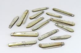 A large collection of silver-bladed fruit knives