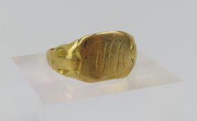 An 18ct gold signet ring, the head with worn monog