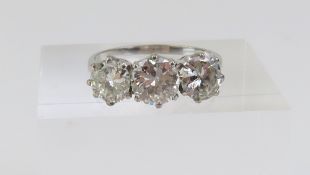An impressive diamond three stone ring, the round