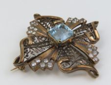 A mid-20th century aquamarine and white stone broo