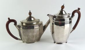 A silver hot water pot and teapot