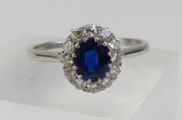 A sapphire and diamond cluster ring, the oval deep