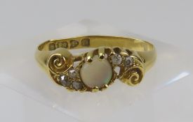 An 18ct gold white opal and diamond dress ring, th