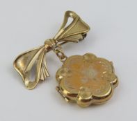A locket with decorative engraving and the letter