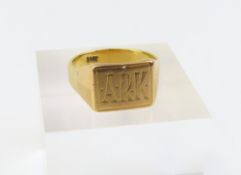 A gold signet ring with a rectangular shaped head