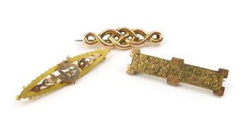 A two colour brooch with cut out decoration of a b